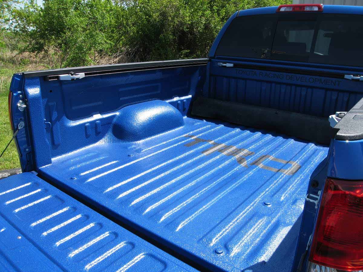 blue colored spray on truck bedliner texturized