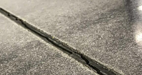 Prepping and Spraying Cracks And Expansion Joints On Concrete Surfaces.