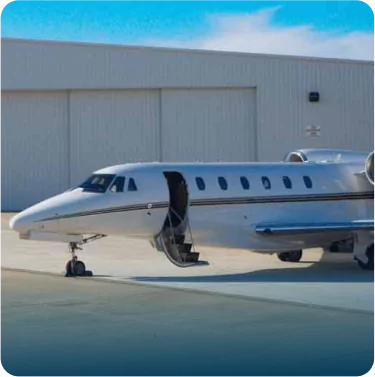 Private jet parked at hangar