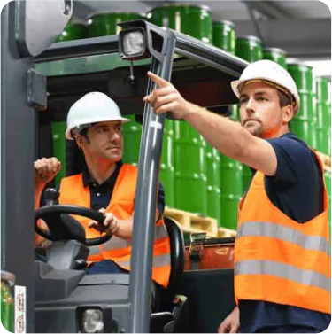Warehouse with forklift green barrels