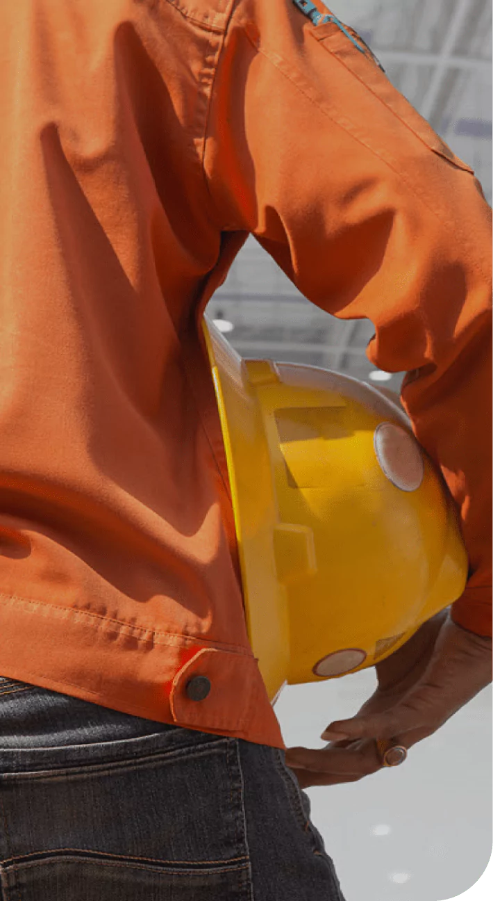Industrial worker holding a yellow safety helmet