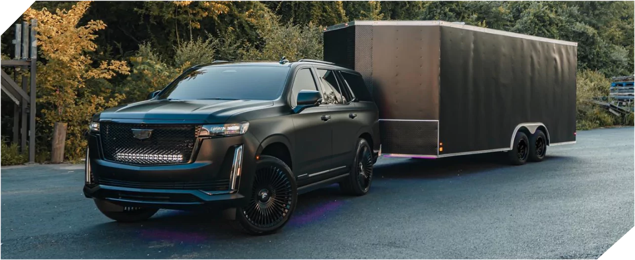 Luxury SUV towing an enclosed trailer