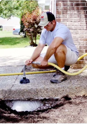 Man apply foam concrete lifting repair