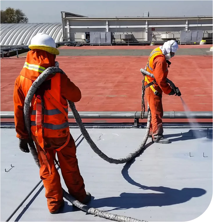 Two workers applying ArmorThane coating