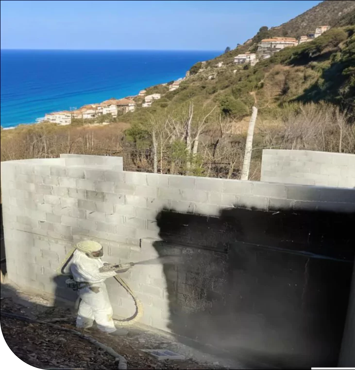 spraying waterproof coating on wall