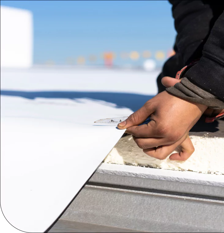 Worker installing TPO roofing membrane
