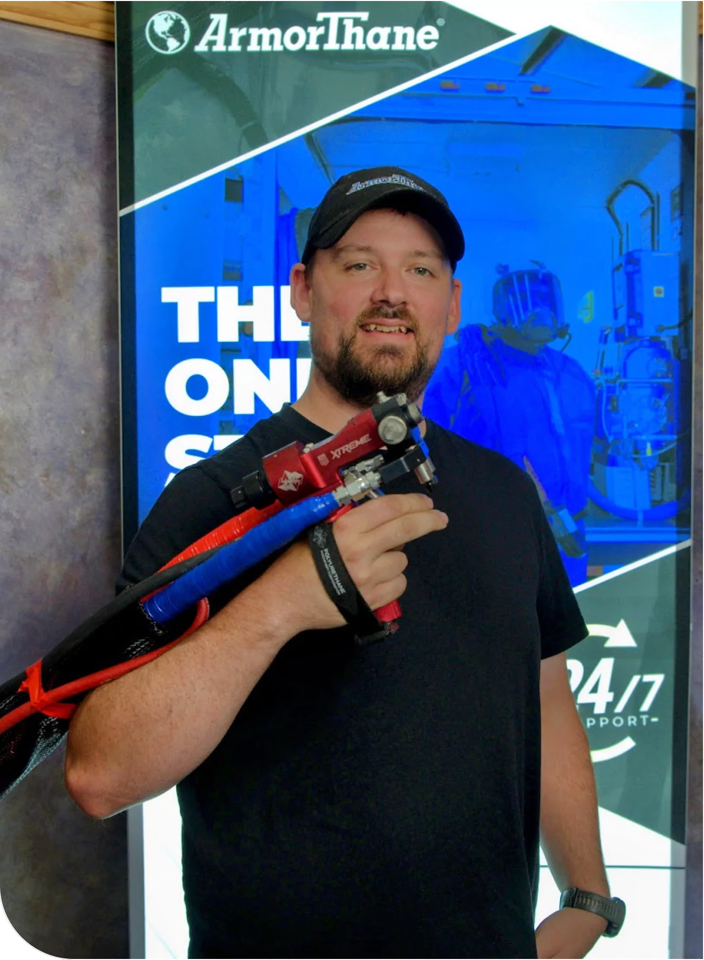 Man holding a spray coating gun at ArmorThane