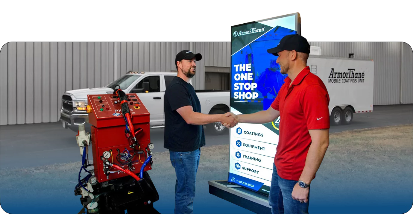 Two men shaking hands near ArmorThane equipment